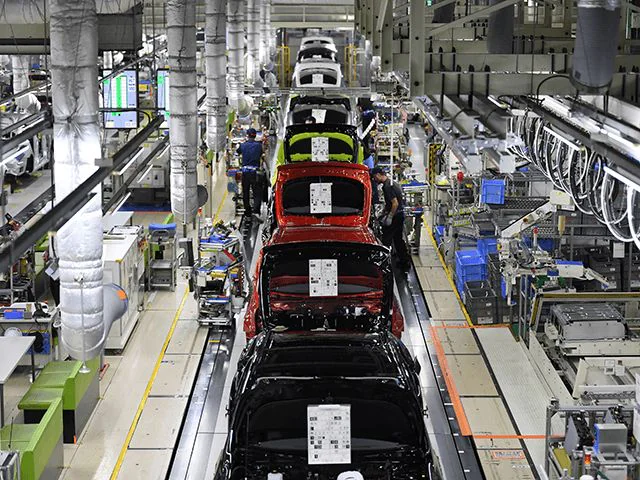 Toyota factory production line with colorful cars in assembly.